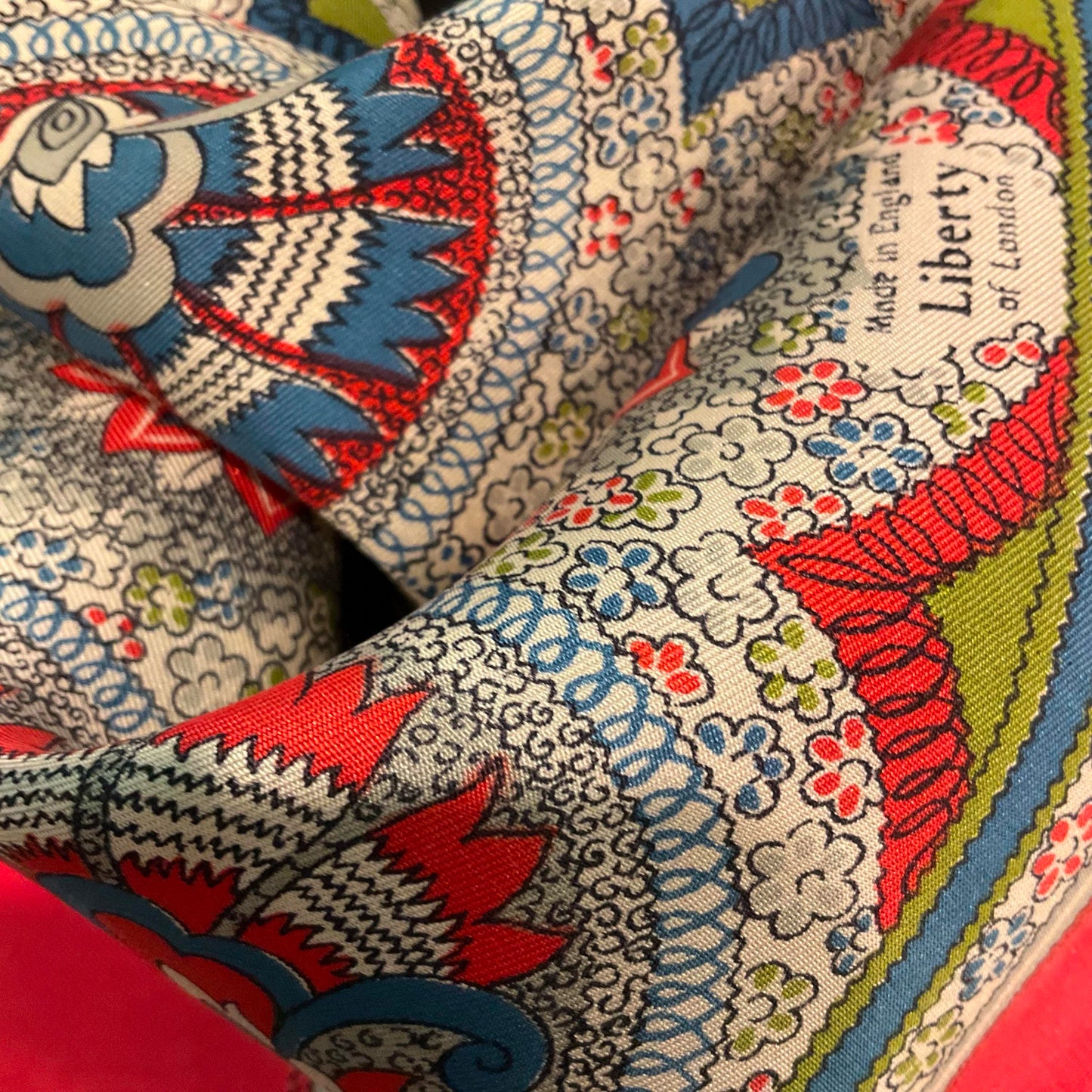 Vintage 1950s/60s pure silk geometric Paisley scarf, coral, blue, green and grey onto a pale cream background, made in England.