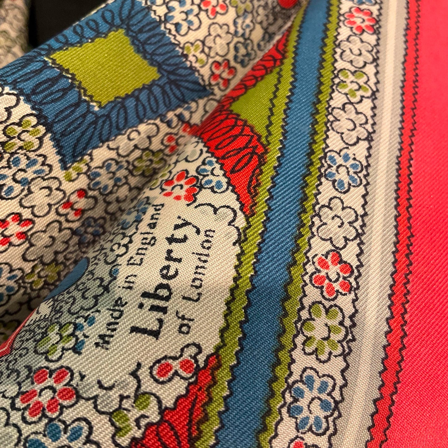 Vintage 1950s/60s pure silk geometric Paisley scarf, coral, blue, green and grey onto a pale cream background, made in England.