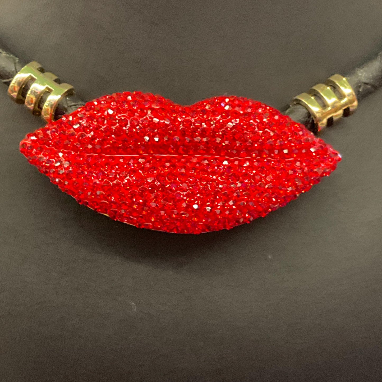 Vintage Butler and Wilson Crystal Lips Leather Necklace, gold tone with red rhinestones and black braided leather