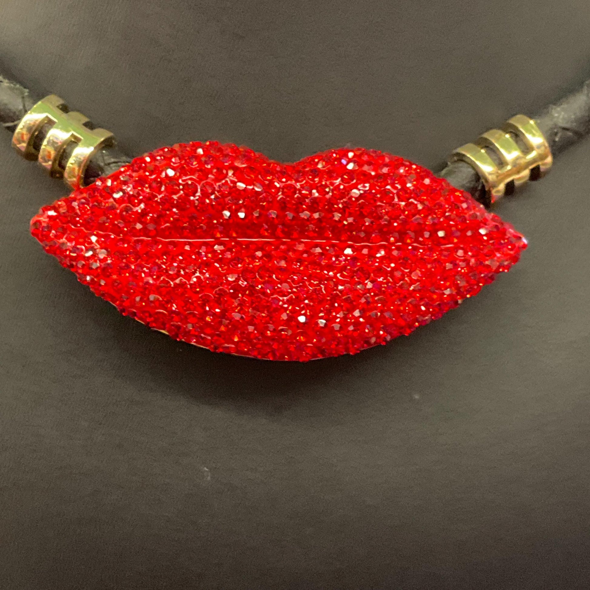 Vintage Butler and Wilson Crystal Lips Leather Necklace, gold tone with red rhinestones and black braided leather