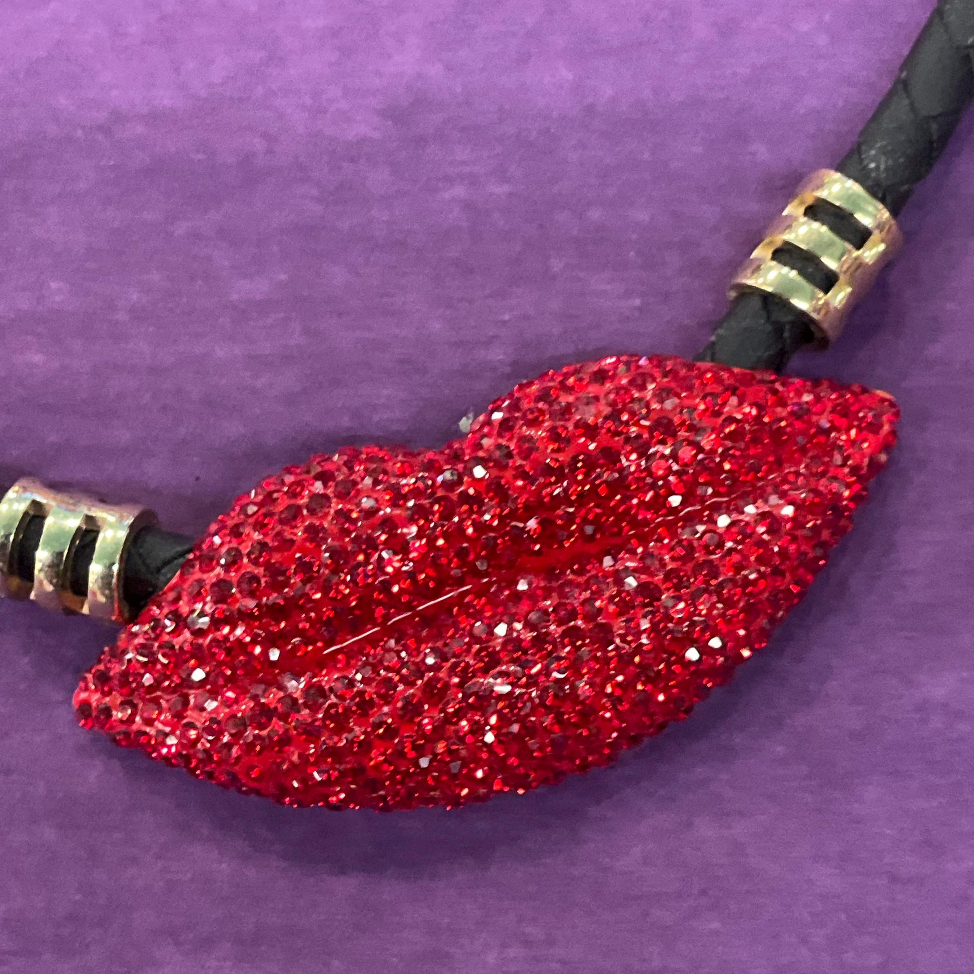 Vintage Butler and Wilson Crystal Lips Leather Necklace, gold tone with red rhinestones and black braided leather