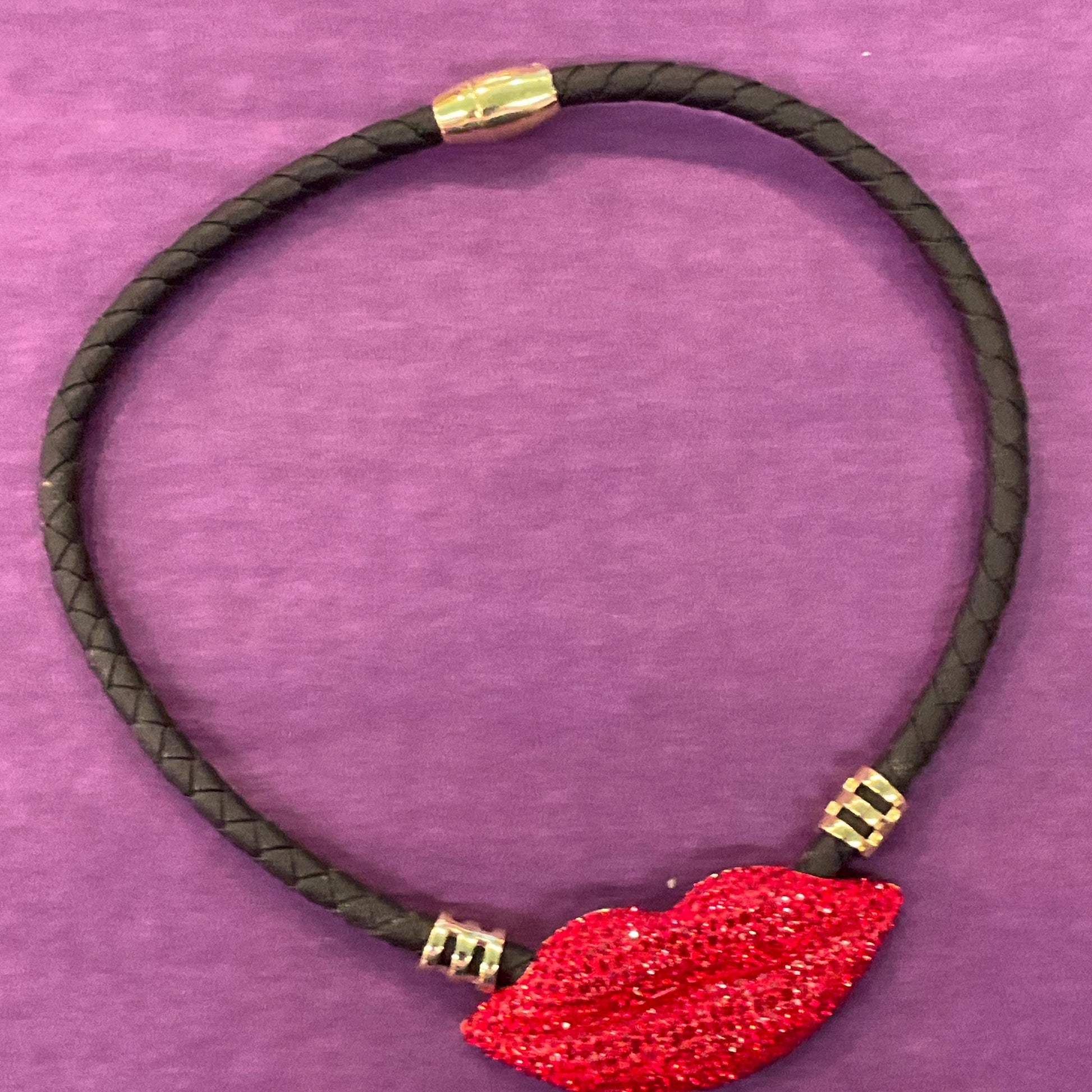 Vintage Butler and Wilson Crystal Lips Leather Necklace, gold tone with red rhinestones and black braided leather