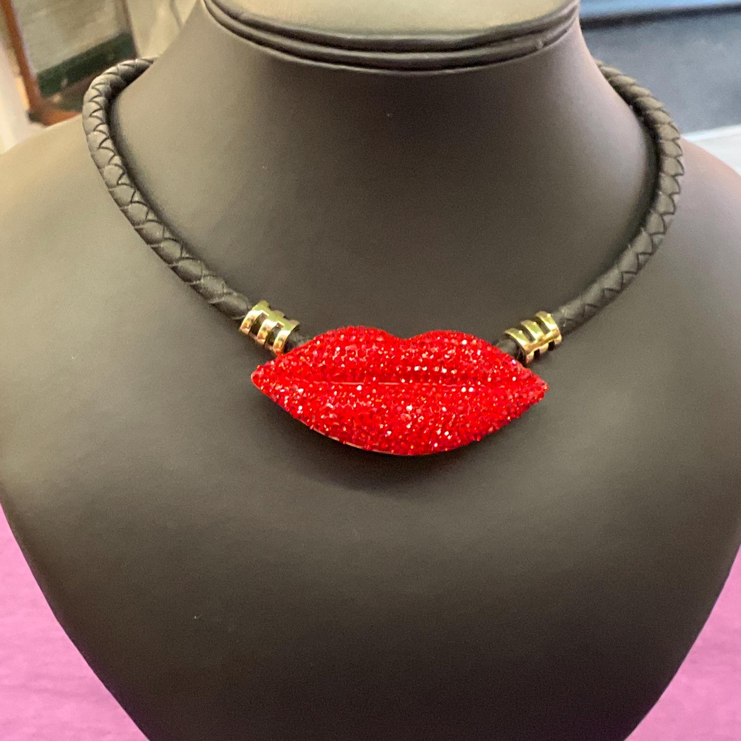 Vintage Butler and Wilson Crystal Lips Leather Necklace, gold tone with red rhinestones and black braided leather