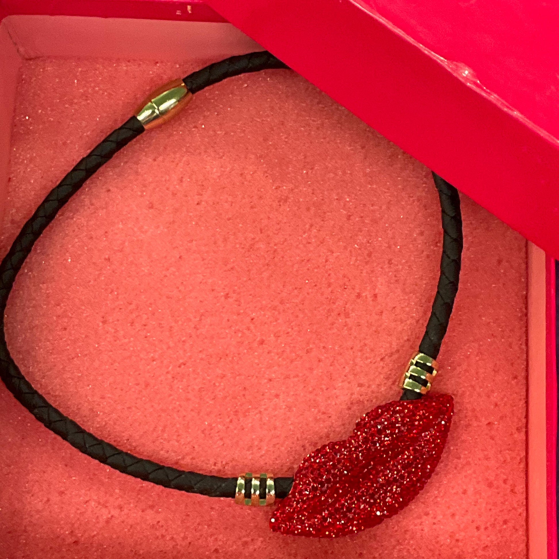 Vintage Butler and Wilson Crystal Lips Leather Necklace, gold tone with red rhinestones and black braided leather